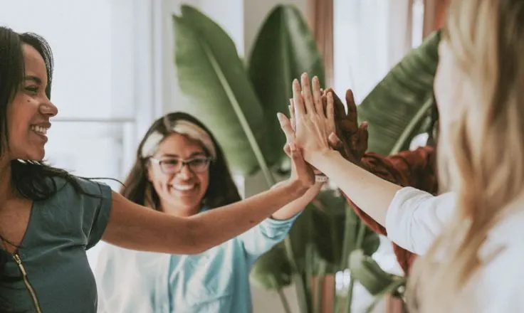 group of people touching hands