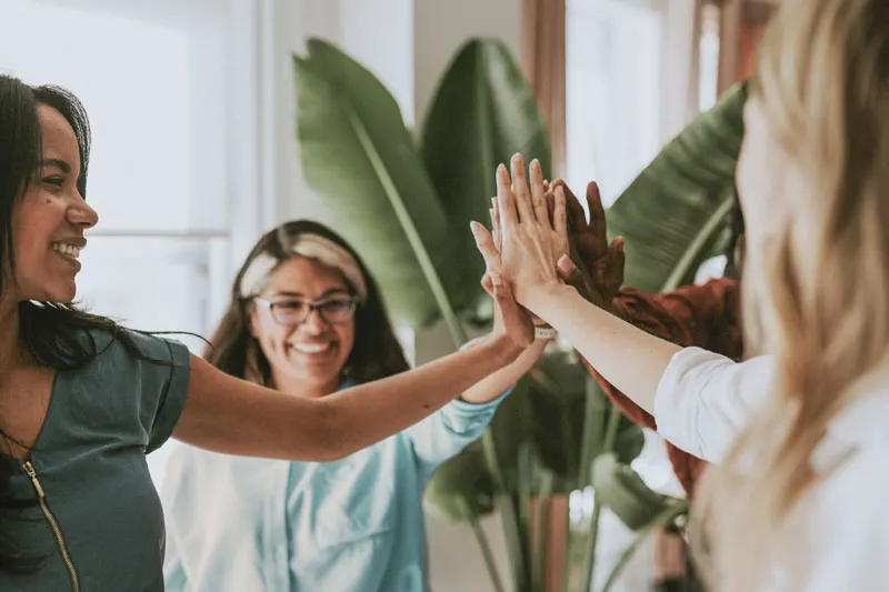 group of people touching hands