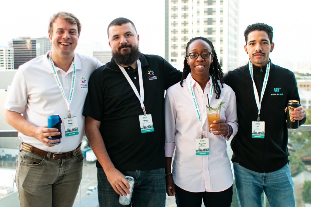 4 mediavine employees standing on a balcony