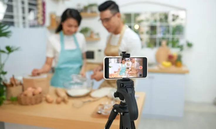two people recording a cooking video