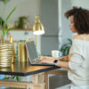 woman using computer at home desk