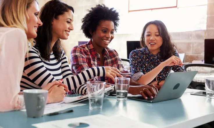 women looking at a laptop together