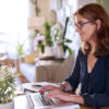 woman sitting at home using laptop