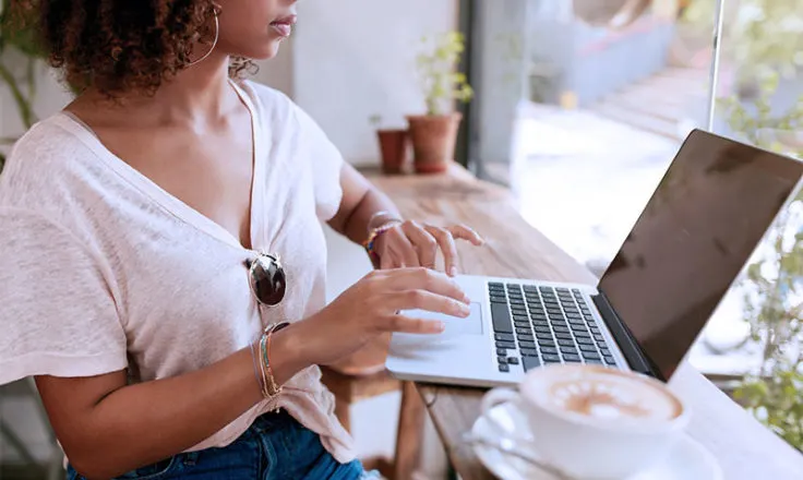 woman using computer at a cafe