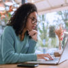 woman using computer at a restaurant cafe