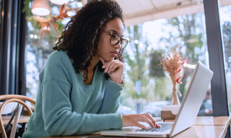 woman using computer at a restaurant cafe