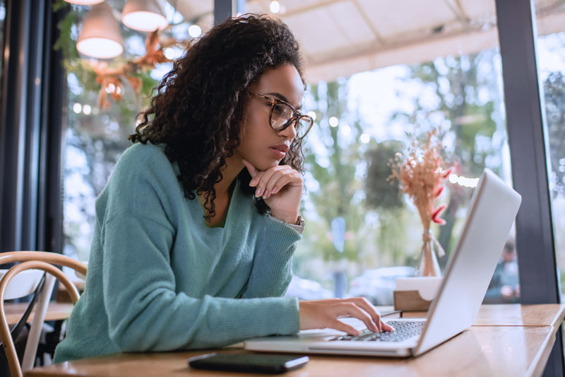 woman using computer at a restaurant cafe