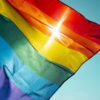 rainbow flag flying against the sky