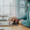 person typing on a laptop at a desk