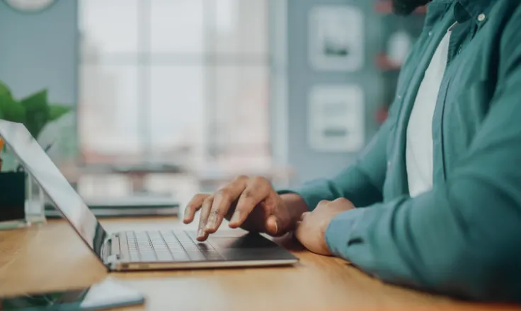 person typing on a laptop at a desk