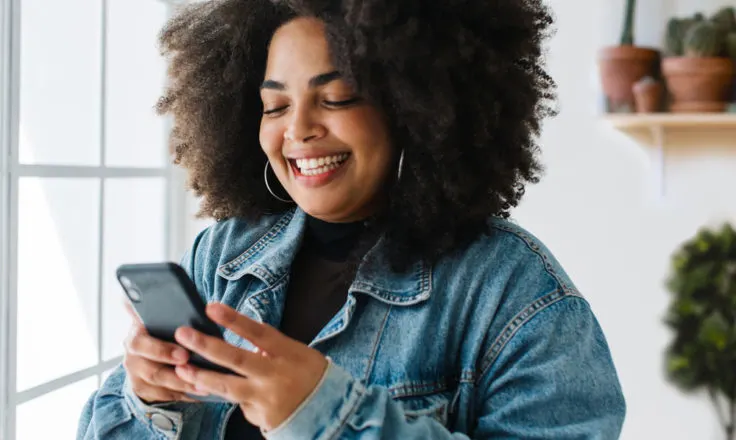 person looking at phone, smiling