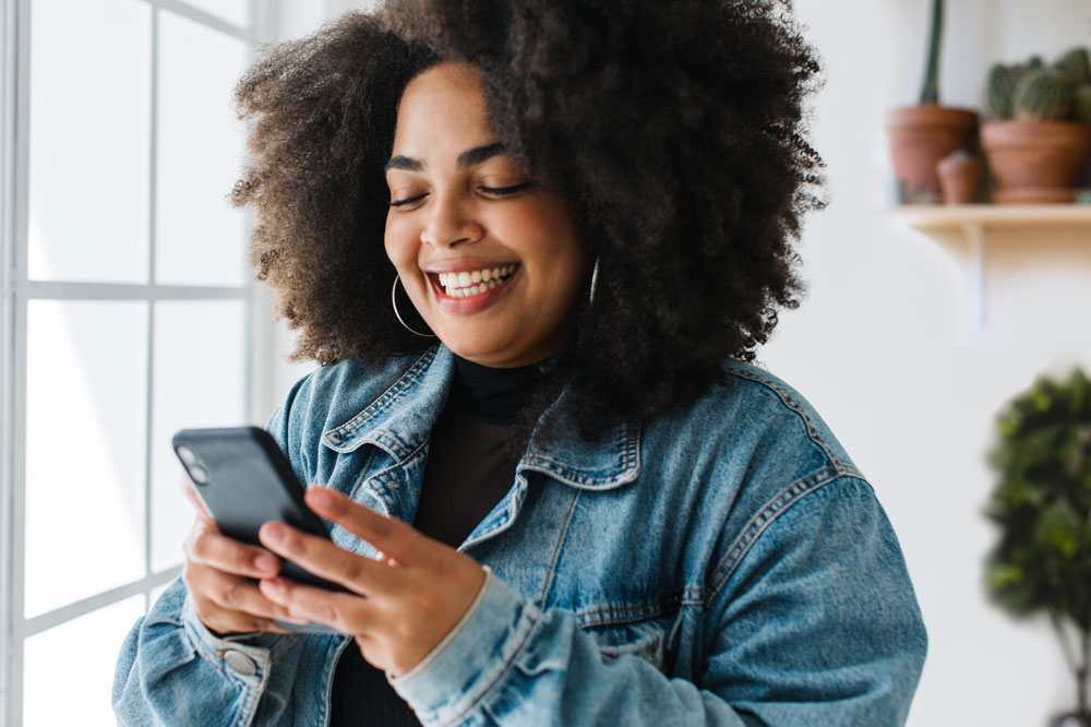 person looking at phone, smiling