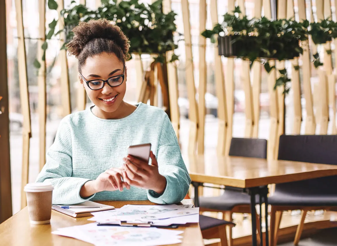 woman in a cafe using a phone