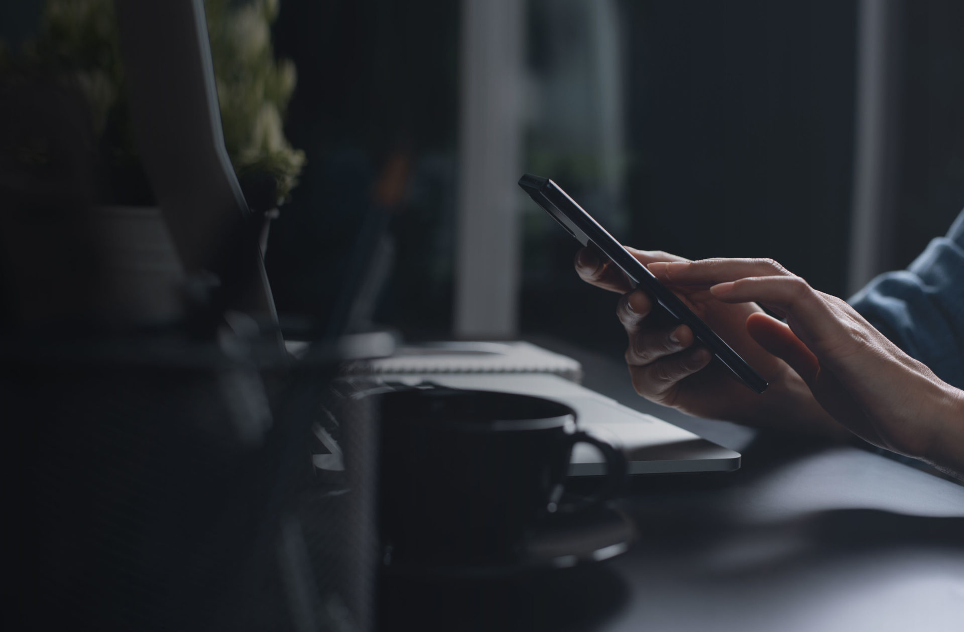 person's hands using a phone