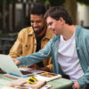 2 men looking at a computer