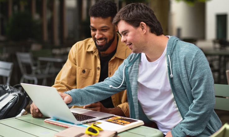 2 men looking at a computer