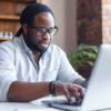man using laptop in a home office