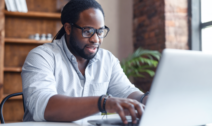 man using laptop in a home office