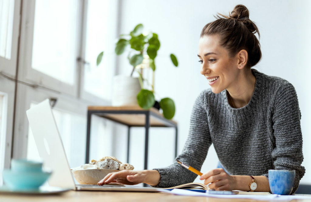 Woman at Computer Plant Background