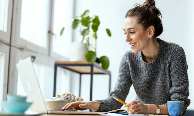 Woman at Computer Plant Background