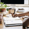 person using a planner at a desk