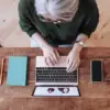 Person typing on a laptop birds eye view