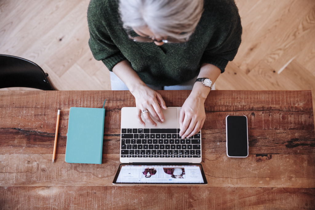 Person typing on a laptop birds eye view