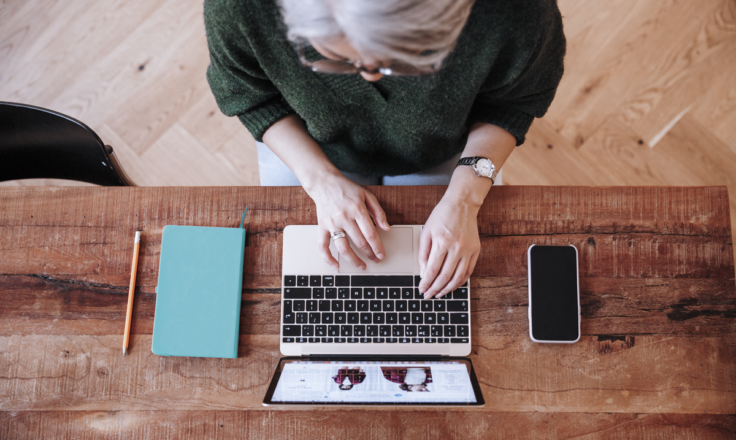 Person typing on a laptop birds eye view