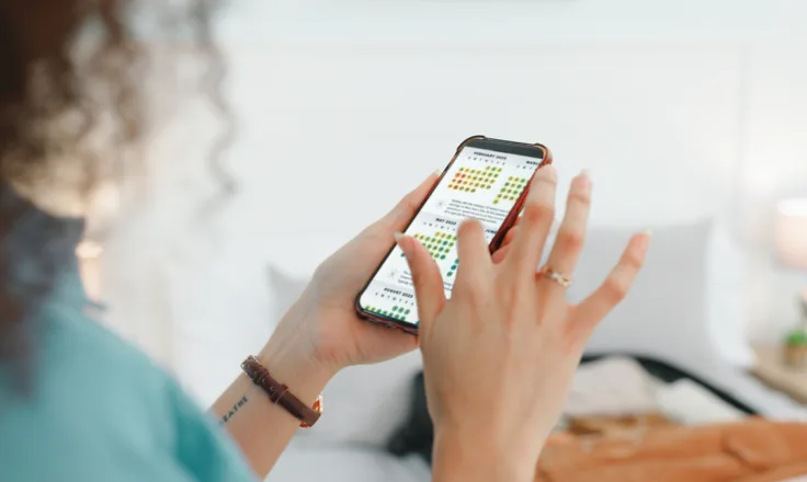 person using their phone with the ecpm calendar on it.